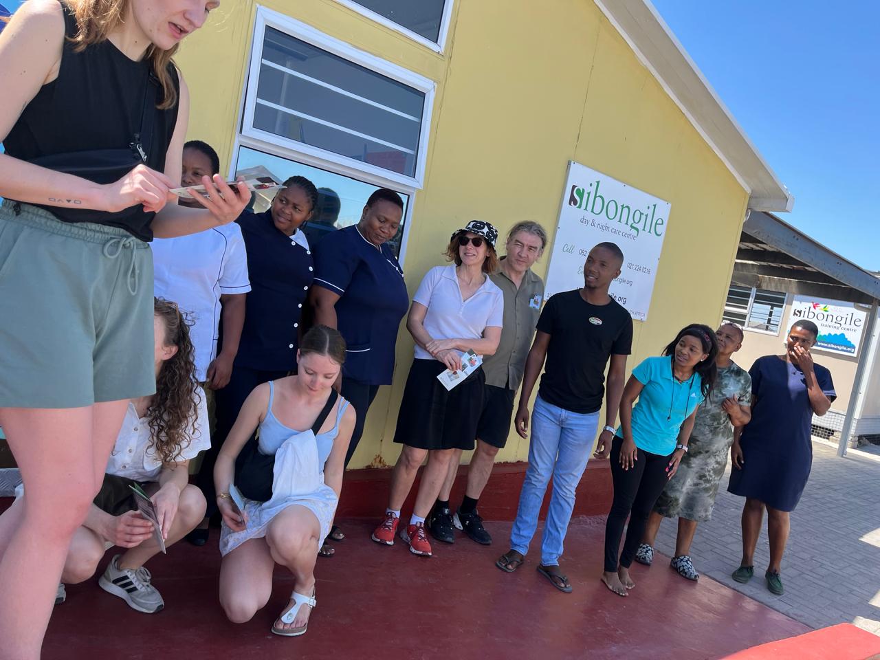 Guide and guests visiting a local day and night care centre