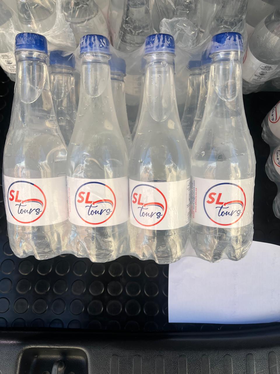 Bottled water branded with the SL Tours logo, ready for a tour