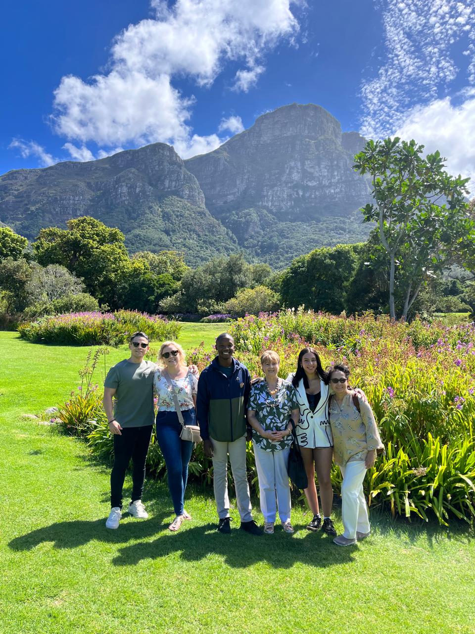 Tour group with guide at Kirstenbosch Gardens, Table Mountain behind