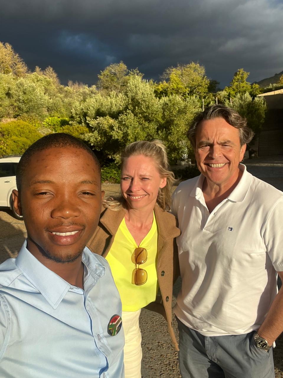 Guide and guests at a Winelands estate under a dramatic sky