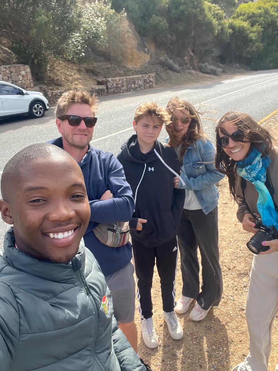Guide and family group on a windy Cape Peninsula mountain road