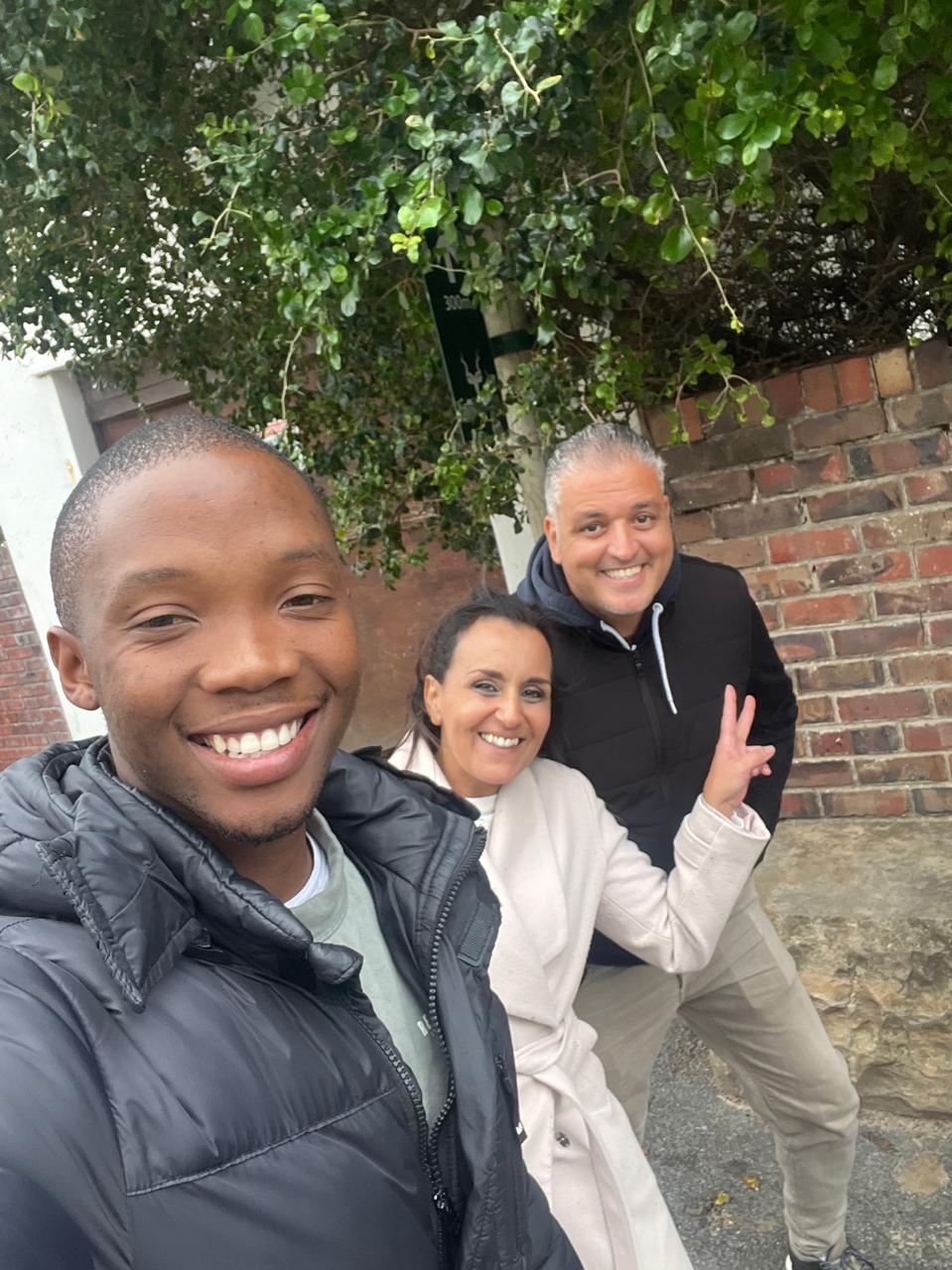 Guide and guests posing under a tree along the Garden Route