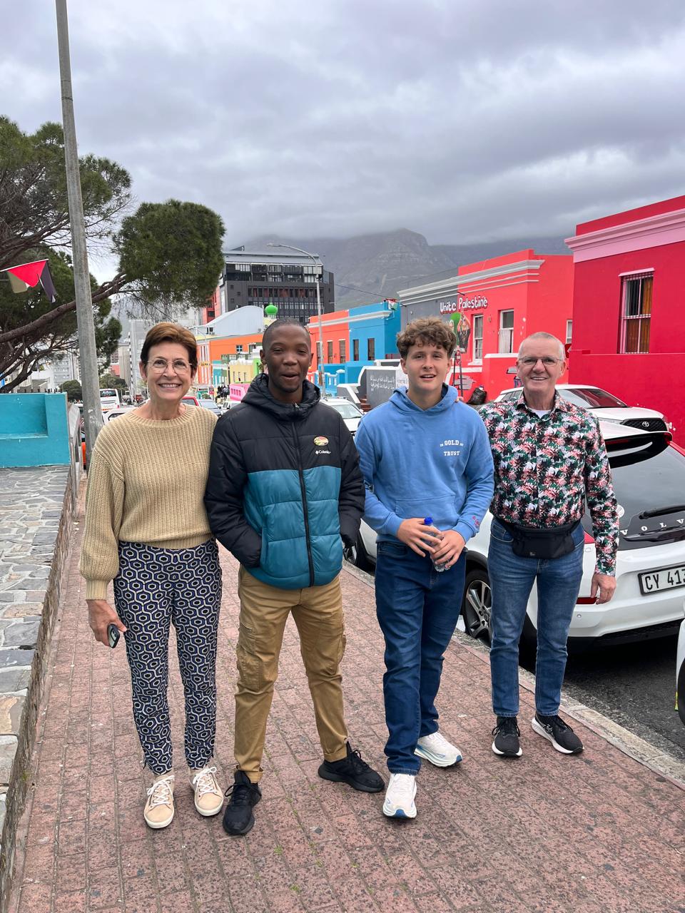 Guide and guests on a colorful Bo-Kaap street, Cape Town