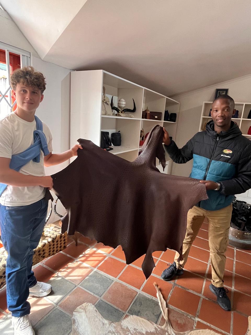 Guide and guest examining an ostrich hide on the Garden Route