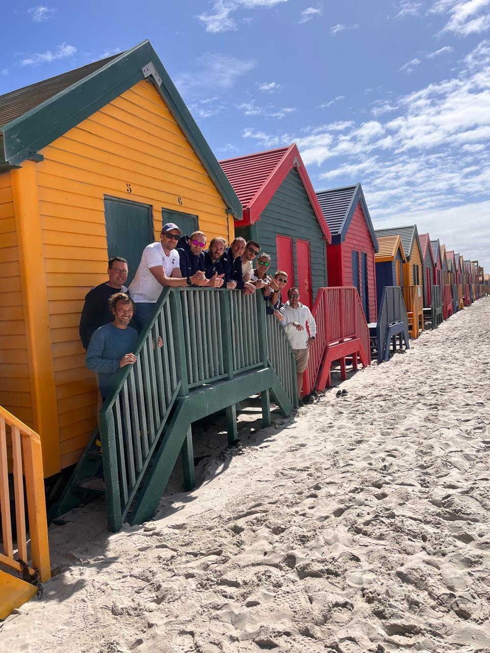 Group of guests at the colorful Muizenberg beach huts